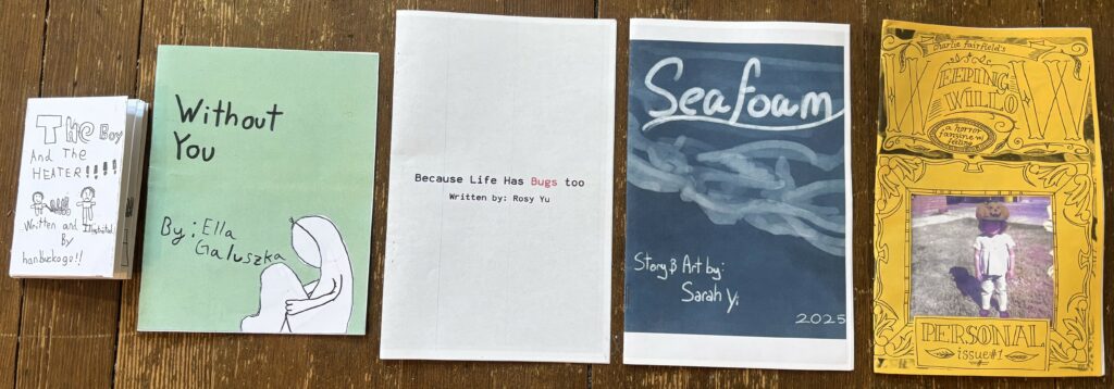 a photo of the five winning zines for the 10th annual washington state zine contest. Pre 4th: The Boy and the Heater by Ronald Han Lethcoe, University Place 4-6: Without You by Ella Reneé Galuszka, Tacoma 7-9: Because Life Has Bugs Too by Rosy Yu, Mercer Island 10-12: Seaform by Sarah Yi, Sammamish Adults: Weeping Willow Issue #1: Personal by Charlie Fairfield, Battleground